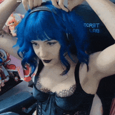 a woman with blue hair is wearing headphones and a bra that says secret lab on it