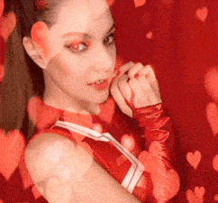 a woman in a red cheerleading uniform is surrounded by hearts