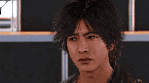a close up of a man 's face with a serious expression