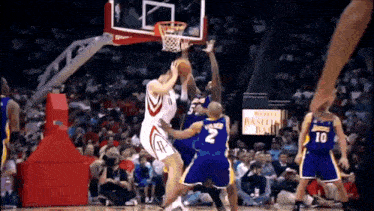 a basketball game is being played in front of a sign that says rockets basement ball