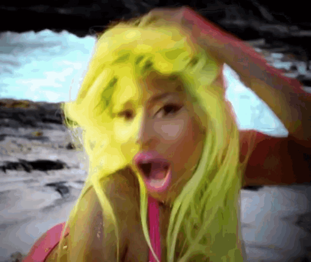 a woman in a pink bikini with bright yellow hair