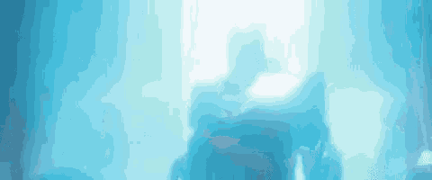 a silhouette of a person standing in a foggy room in front of a blue light .