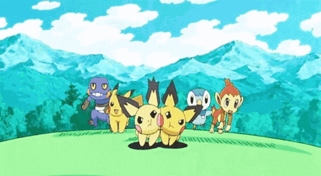 a group of pokemon standing on top of a grassy hill with mountains in the background