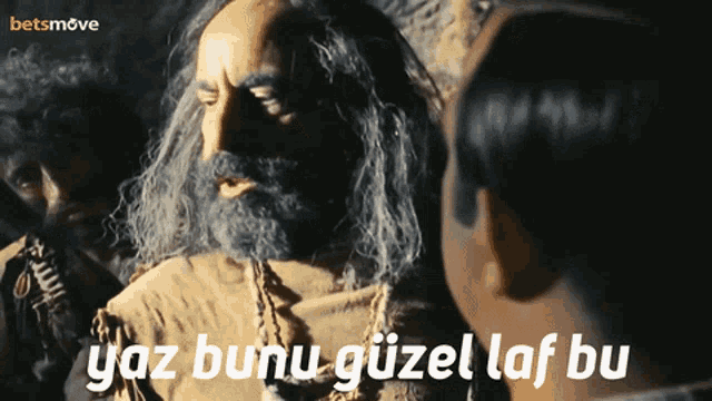 a man with a beard is talking to another man with the words yaz bunu güzel laf bu written below him