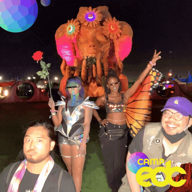 a group of people standing in front of a giant sculpture that says carnival on it
