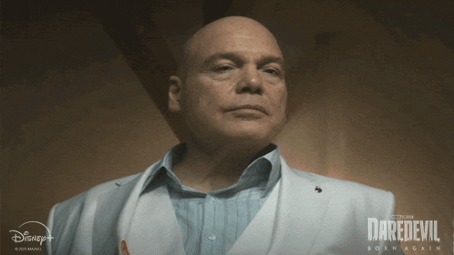 a bald man in a white suit with the word daredevil on it