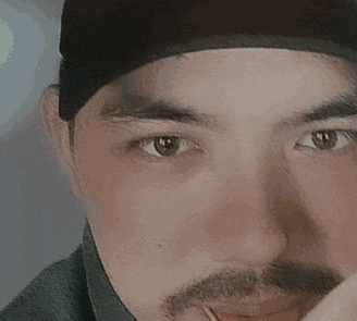 a pixelated image of a man 's face with a blurred background