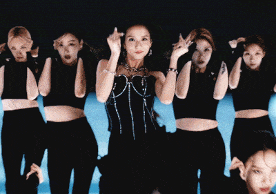 a group of women are dancing in front of a keyboard that has the letter u on it
