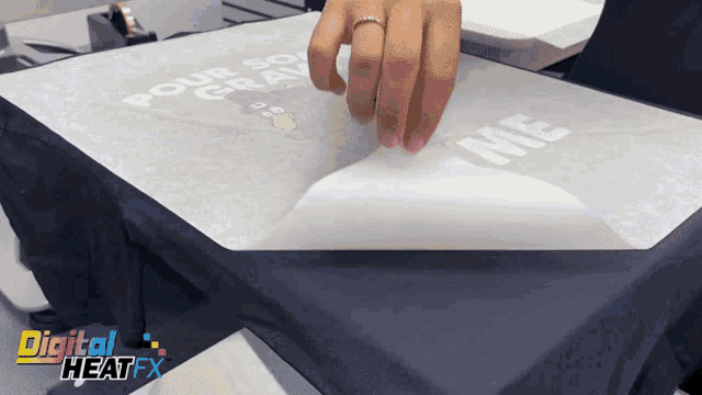 a person is putting a piece of paper on a shirt that says pour so gravy on it