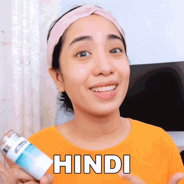 a woman holding a bottle with the word hindi on her shirt