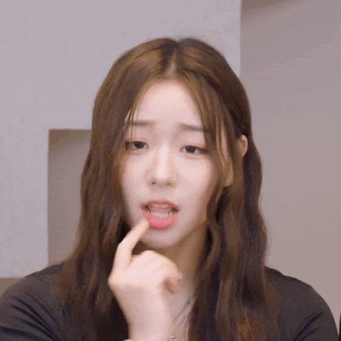 a woman with long brown hair is making a funny face