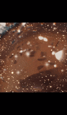 a close up of a brown background with a lot of sparkles
