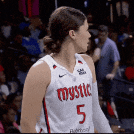a female basketball player wearing a mystic jersey