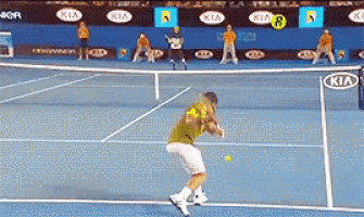 a man playing tennis on a court with kia advertisements behind him