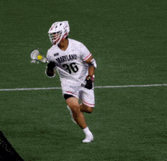 a lacrosse player wearing a jersey that says maryland on the front