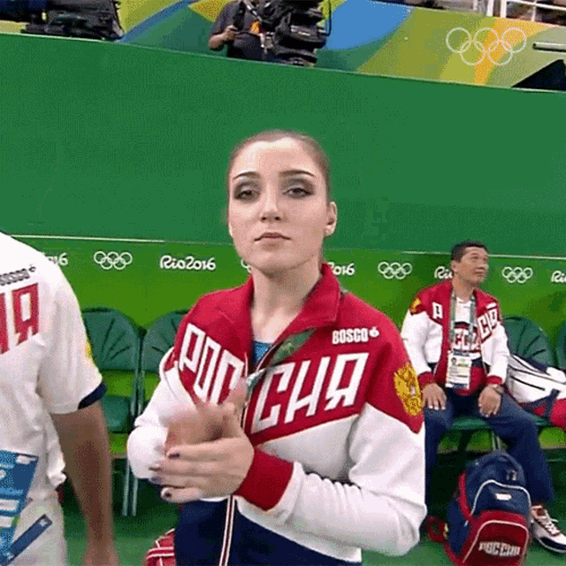a woman wearing a red white and blue jacket that says bosco on it