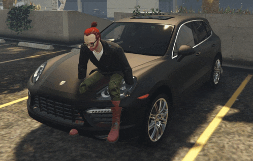 a man with red hair sits on the hood of a black porsche