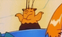 a close up of a cartoon character with orange hair standing in a blue bowl