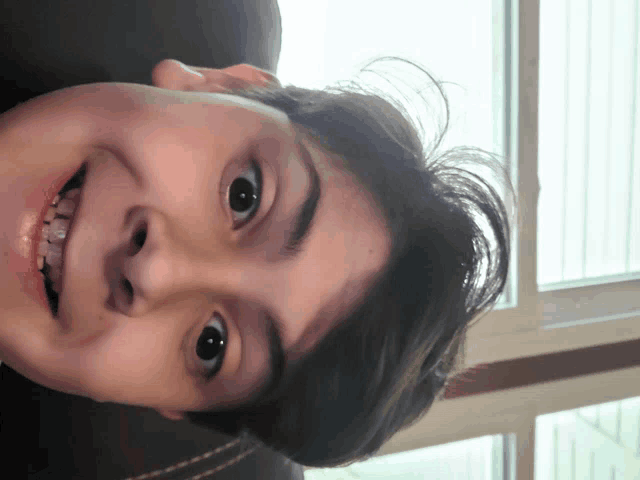 a close up of a person 's face with a smile on it
