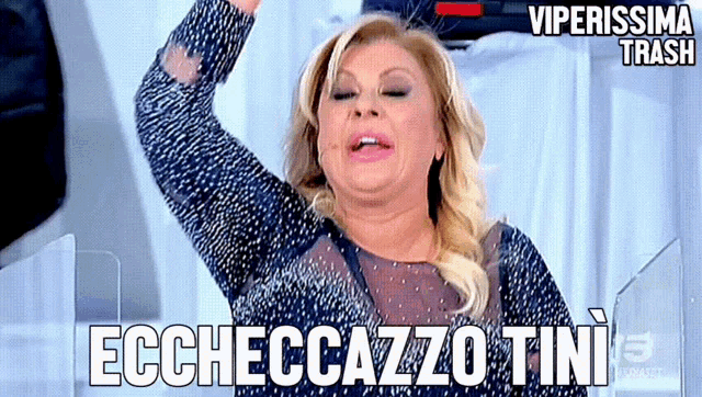 a woman in a blue dress says " ecchecco tini "