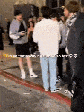 a group of people are standing on a sidewalk with a caption that says oh so thats why he turned so fast