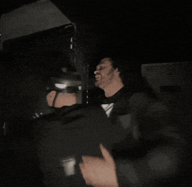 a person with blood on their pants is being held by someone with a flashlight