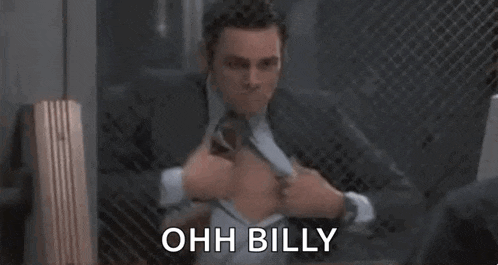a man in a suit and tie is ripping his shirt open and says ohh billy .
