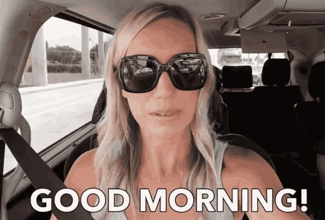 a woman wearing sunglasses is sitting in a car with the words good morning behind her