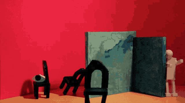 a red wall with a blue book and a chair