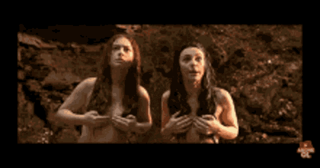 two naked women standing next to each other with their hands on their chests