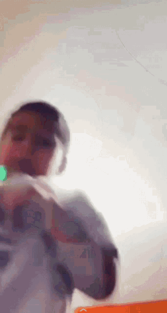 a blurry picture of a person holding a green object