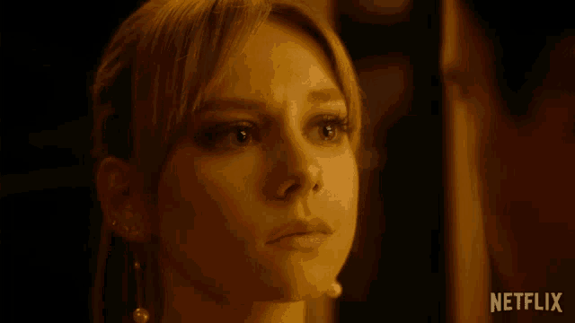 a close up of a woman 's face with a netflix logo on the bottom