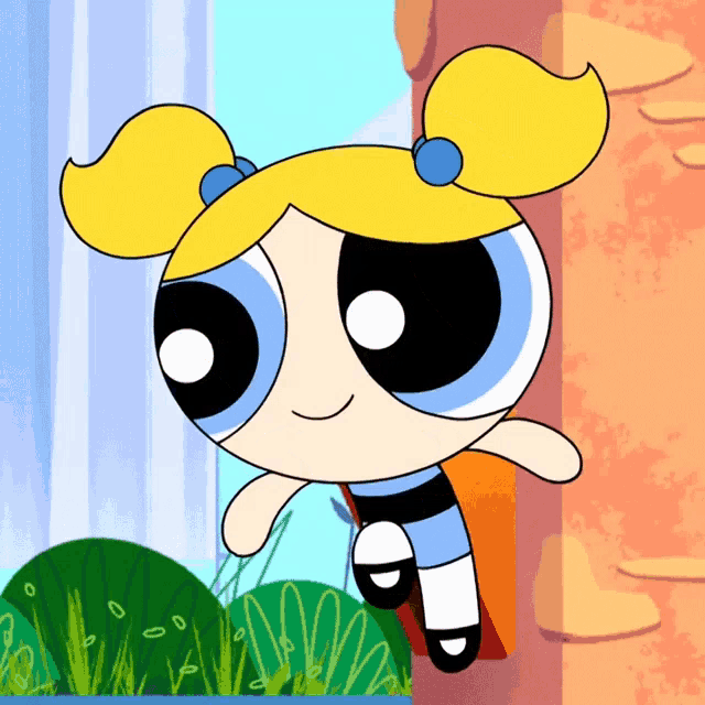 bubbles from the powerpuff girls stands in front of a wall