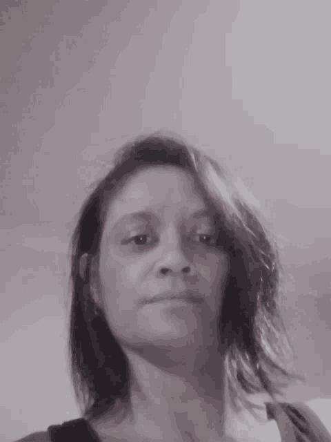 a black and white photo of a woman with a serious look on her face