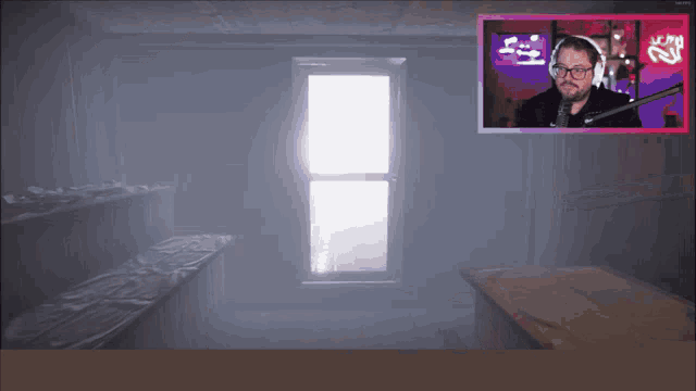 a man wearing headphones and glasses is playing a game