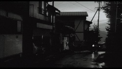 a black and white photo of a street with a sign that says ' a '