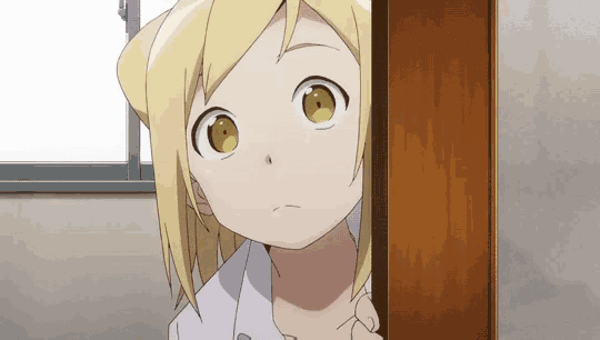 a girl with blonde hair and yellow eyes is peeking out from behind a wooden cabinet