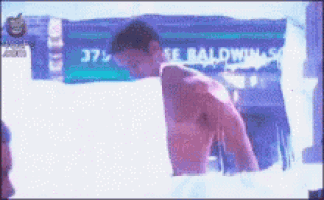 a shirtless man is standing in front of a sign that says ' 37 ' on it