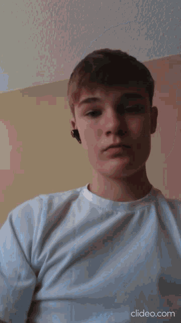 a close up of a young man 's face with the website clideo.com in the lower right corner