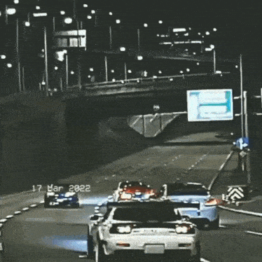 a car is driving down a highway at night with the date 17 mar 2021