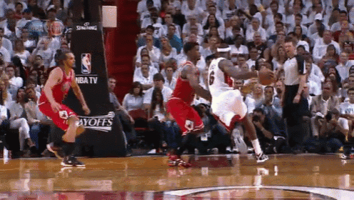 a basketball game is being played in front of a nba tv advertisement