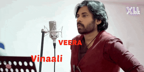 a man singing into a microphone with the name vinaali written on the bottom