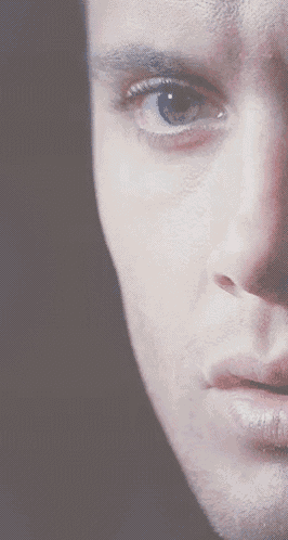 a close up of a man 's face with his eyes visible