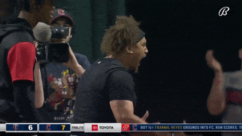 a baseball player screams in front of a toyota logo