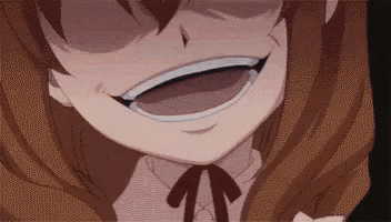 a close up of a girl 's face with a big smile on it .