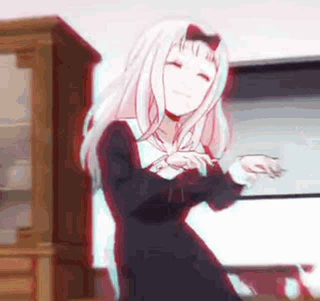 a girl in a black dress is dancing in front of a tv .