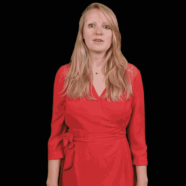 a woman in a red dress is making a surprised face with her mouth open