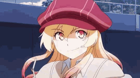 a girl wearing a red hat and glasses is looking at the camera .