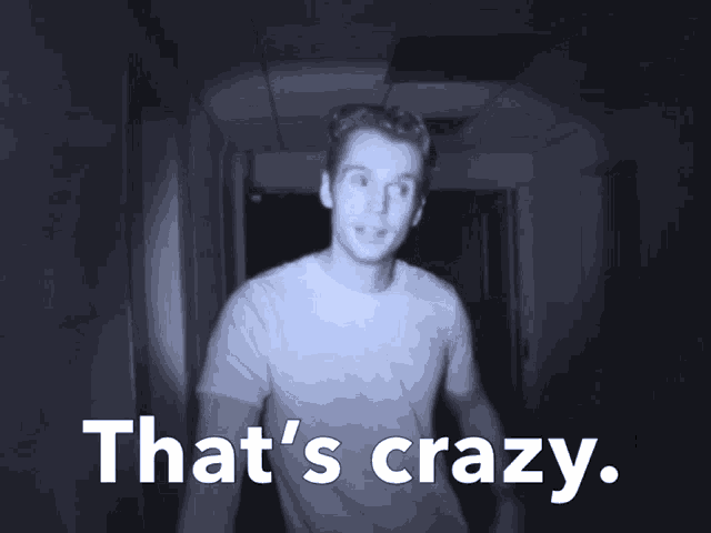 a man in a hallway with the words that 's crazy