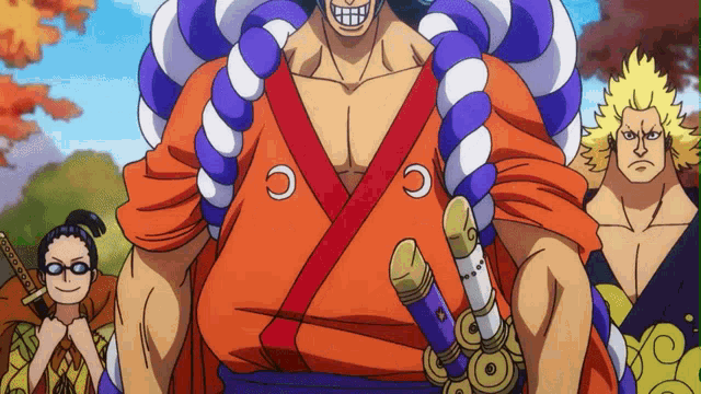 a man in a kimono is holding a sword in front of a group of people